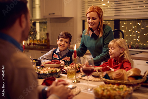 Happy family enjoying in Christmas dinner at dining table.