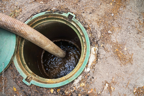 Clogged septic tank. Emptying the septic tank. Pipe in the drainage pit. Sewer cleaning service.