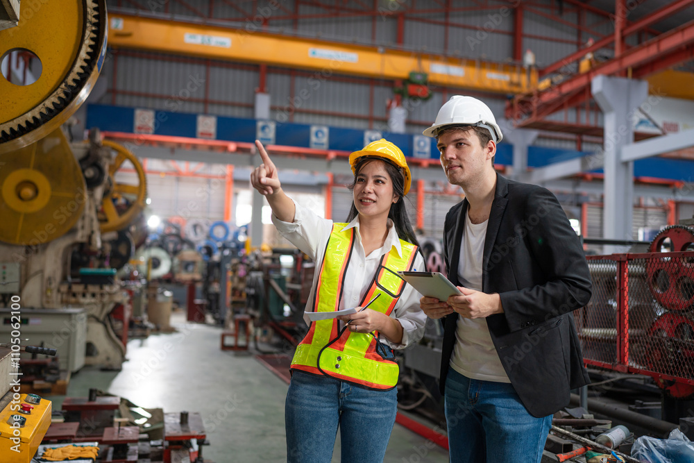 Chief Engineer and Project Manager Wearing Safety Vests and Hard Hats, Talking and planning optimization of production at industrial factory. Chief Engineer and Project Manager Wearing Safety Vests and Hard Hats, Talking and planning optimization of production at industrial factory.