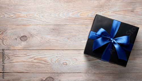 Black Gift Box with Dark Blue Ribbon on Wooden Background. Top View of Father Day Gifts with Copy Space