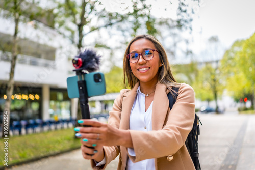 Vlogger smiling while recording new content in the city