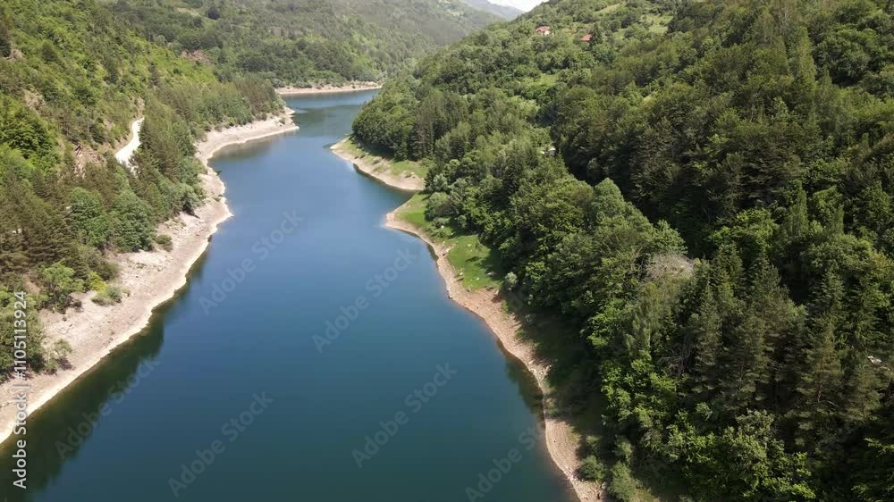 Enjoying the serene beauty of a river surrounded by lush mountains in summer Enjoying the serene beauty of a river surrounded by lush mountains in summer