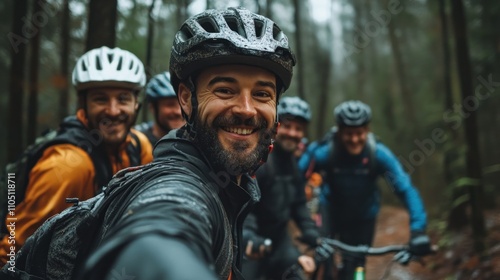 Happy mountain bikers smiling for a selfie in a forest.