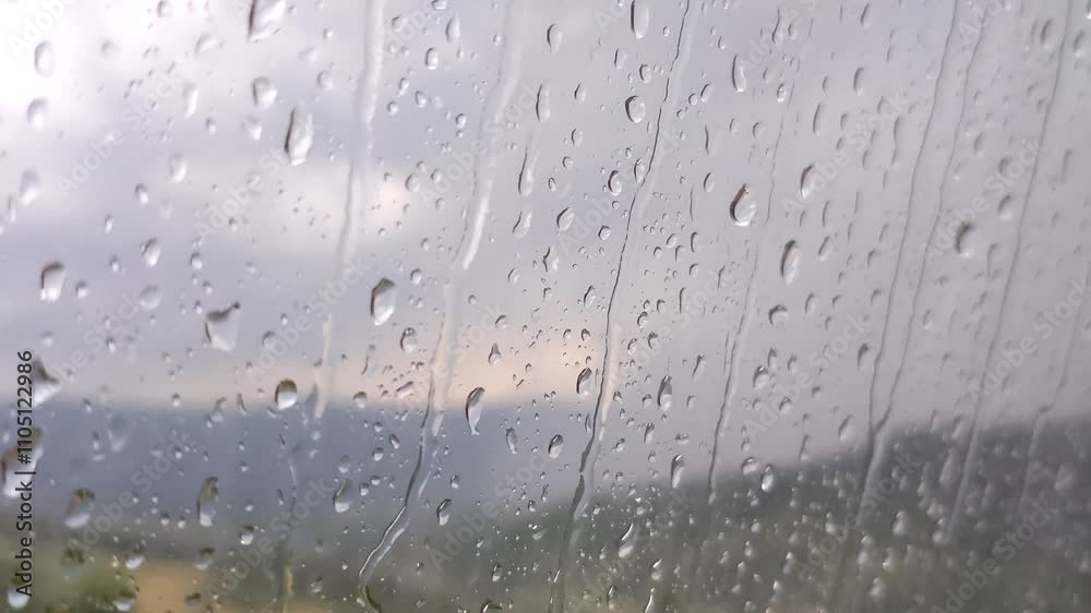Raindrops on the window. Bad weather: thunderstorms and lightning in mountains Raindrops on the window. Bad weather: thunderstorms and lightning in mountains