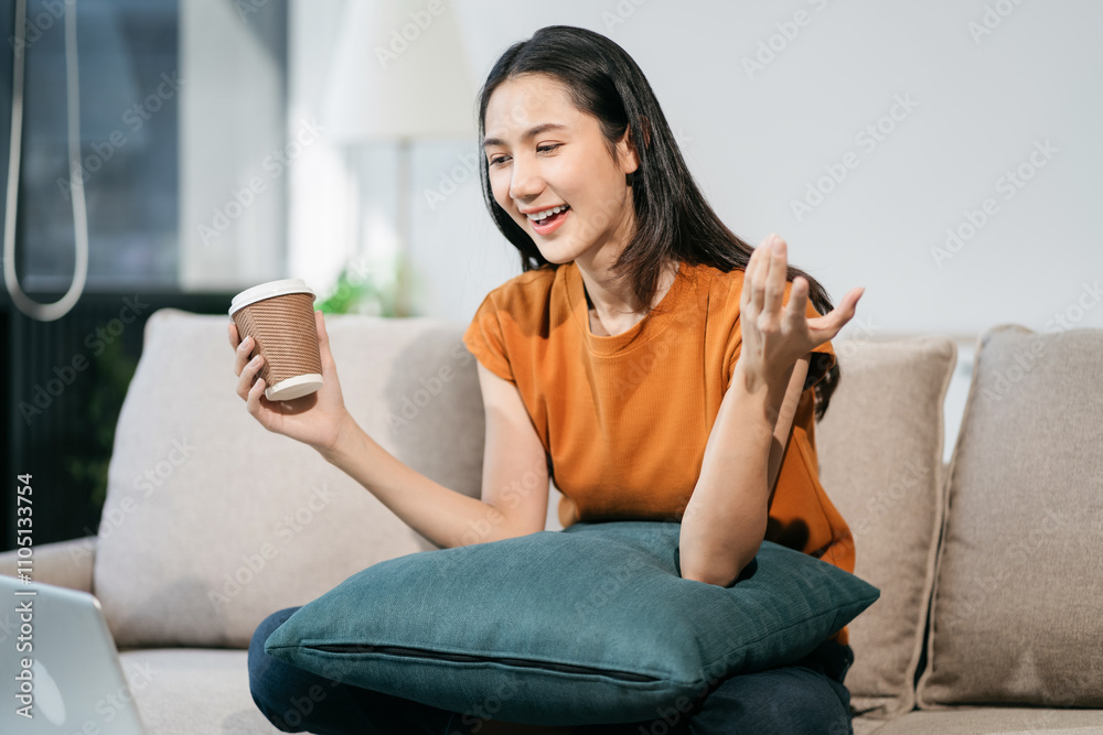 Happy woman having fun doing video call using mobile phone and Laptop sitting on sofa, home office workplace lifestyle people. Happy woman having fun doing video call using mobile phone and Laptop sitting on sofa, home office workplace lifestyle people.