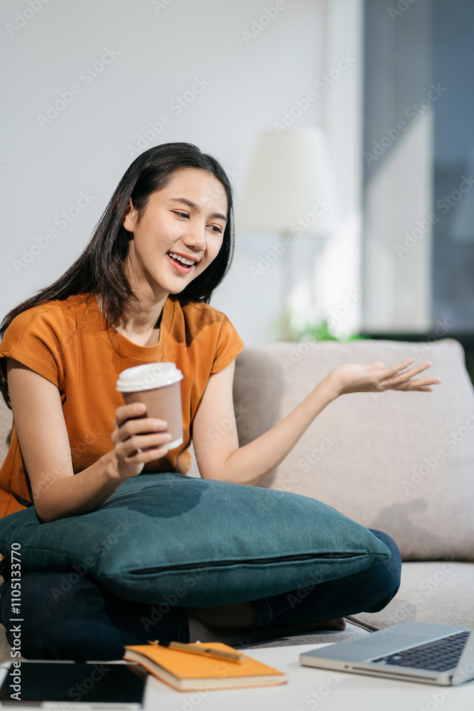Happy woman having fun doing video call using mobile phone and Laptop sitting on sofa, home office workplace lifestyle people. Happy woman having fun doing video call using mobile phone and Laptop sitting on sofa, home office workplace lifestyle people.