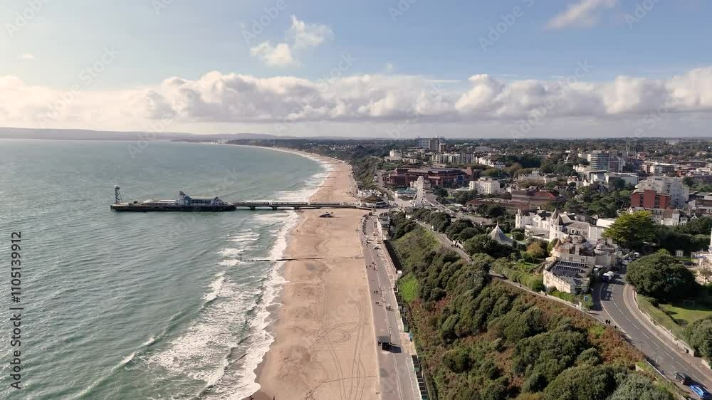 Bournemouth.High Flight along the cliffs at Eastcliffe and beach showing pier,promenade,golden beach and hotels and views over to Poole Harbour entrance and the Isle of Purbeck on bright sunny day Bournemouth.High Flight along the cliffs at Eastcliffe and beach showing pier,promenade,golden beach and hotels and views over to Poole Harbour entrance and the Isle of Purbeck on bright sunny day