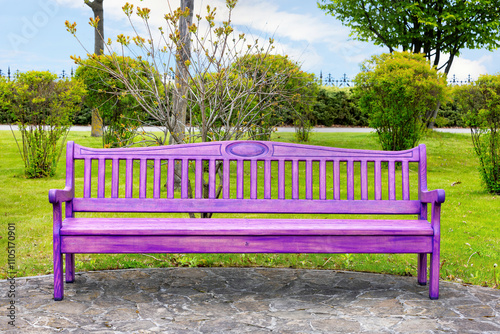 Obraz na płótnie Vibrant purple bench resting peacefully in a lush park under a clear sky w salonie