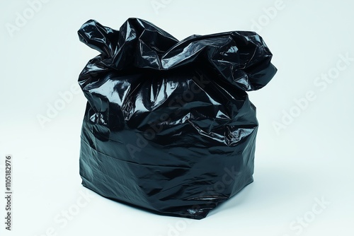 Garbage bag isolated on a white background as a symbol of waste management and environmental issues as a throw away black plastic sack full of dirty smelly trash and useless junk. photo