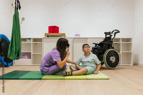 Optometrist performing eye exam on child with cerebral palsy photo