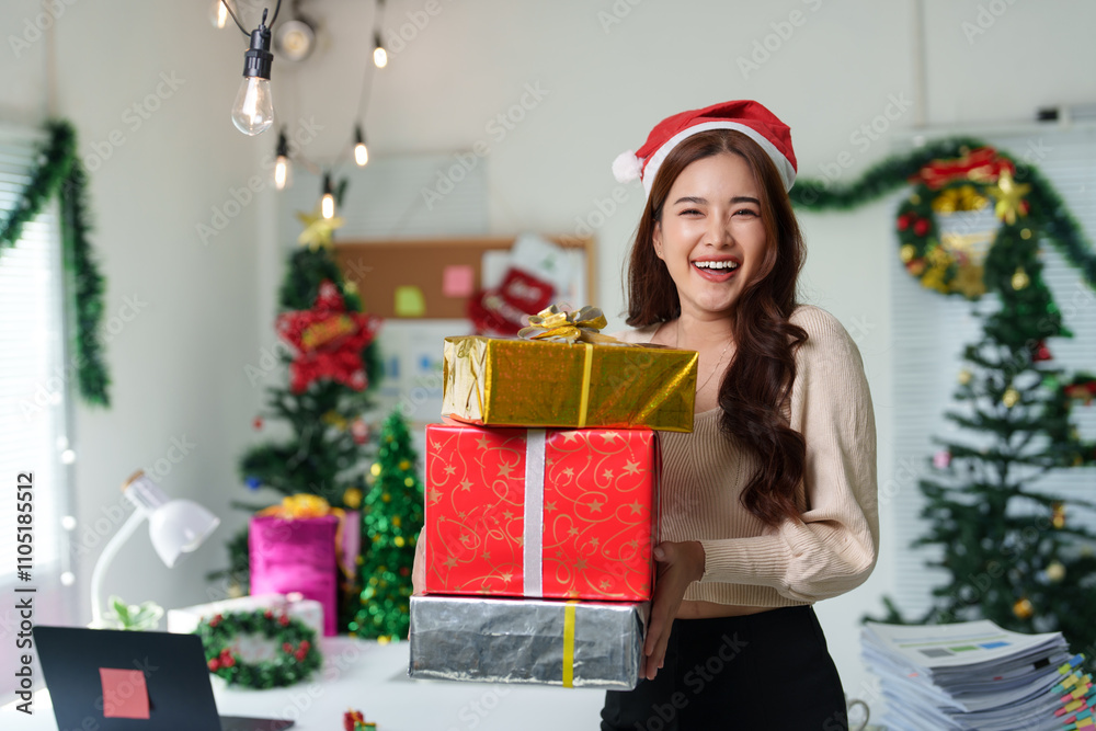 Confident Asian girl holding Christmas gift box in Santa hat smiling and holding presents. Christmas shopping and event ideas Celebration day during long holiday, party. Confident Asian girl holding Christmas gift box in Santa hat smiling and holding presents. Christmas shopping and event ideas Celebration day during long holiday, party.
