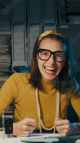 Cheerful woman celebrating in the office