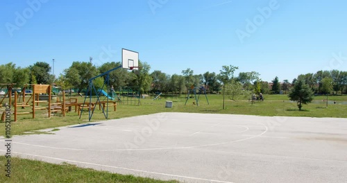 Wallpaper Mural Open playground with basketball court and swings in a sunny park Torontodigital.ca