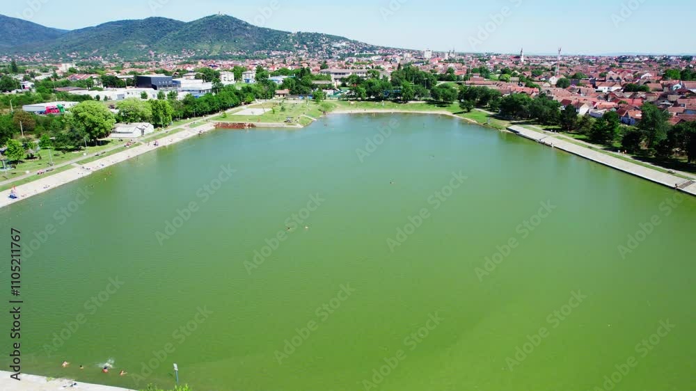Exploring the scenic lake surrounded by vibrant greenery and picturesque hills in warm sunlight Exploring the scenic lake surrounded by vibrant greenery and picturesque hills in warm sunlight