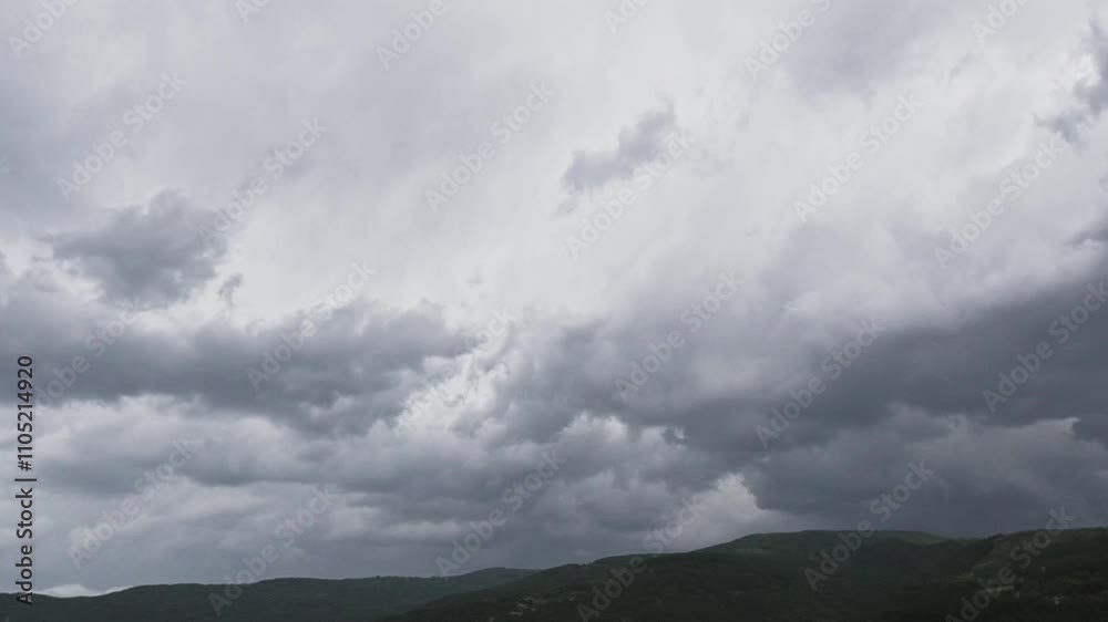 Dramatic cloud formations over mountainous landscape during late afternoon hours Dramatic cloud formations over mountainous landscape during late afternoon hours