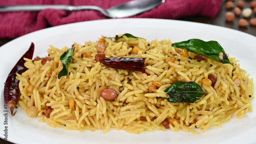 Serving tamarind rice on a white plate. Serving tamarind rice on a white plate.