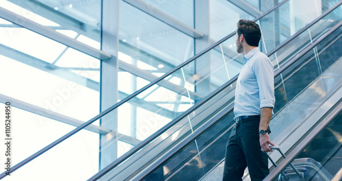 Businessman, escalator and travel at airport with luggage for flight, journey and thinking. Professional trip, worker and suitcase at lobby for arrival, immigration or airline broker with reflection