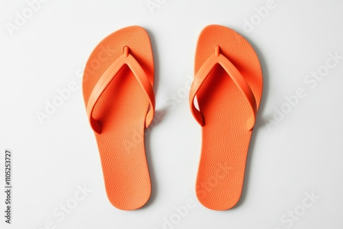 Plain orange rubber flip-flops, arranged neatly on white background