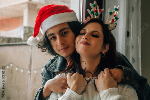 Beautiful couple lauthing together and celebrating christmas day at home photo