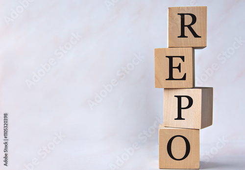 REPO - acronym on wooden cubes on a white background