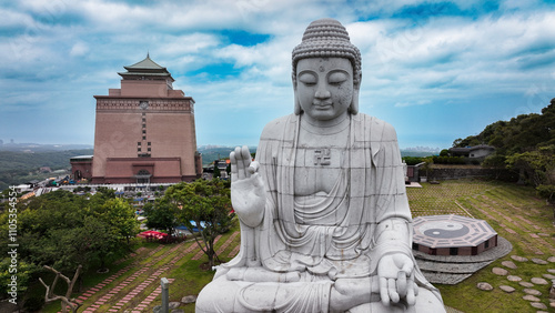 Photography Serene giant Buddha statue overlooking the landscape at a cemetery in Taiwan