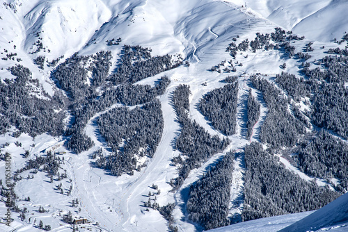 Beautiful landscape of the Arkhyz ski resort with mountains, snow, forest on sunny winter day. Caucasus Mountains, Russia.