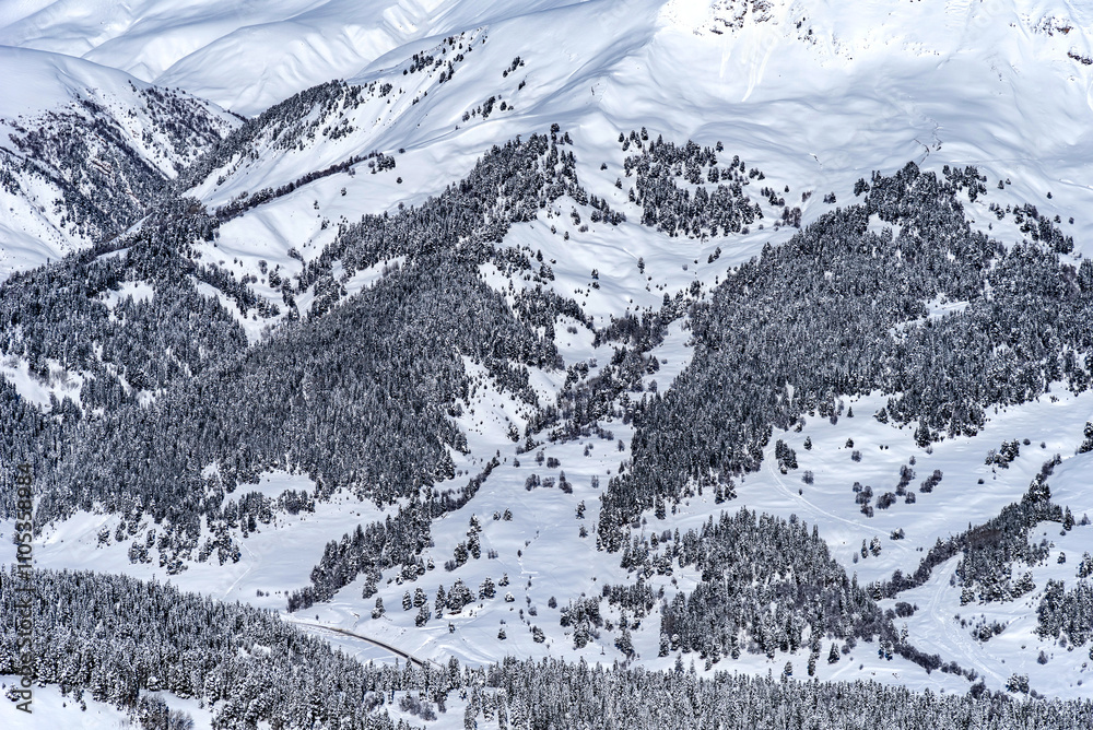 Obraz premium Beautiful landscape of the Arkhyz ski resort with mountains, snow, forest on sunny winter day. Caucasus Mountains, Russia.