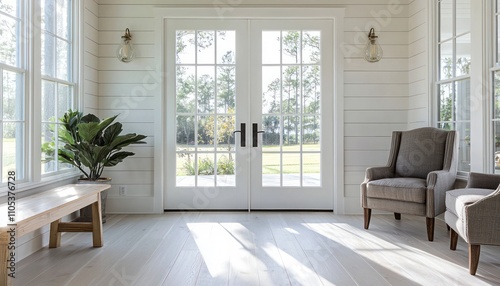 A cozy, modern hallway with double doors, shiplap walls, and plenty of natural light.
