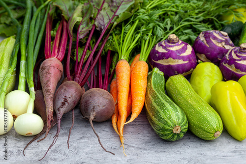 Close-up of fresh vegetables - carrots, beets, zucchini, peppers, cucumbers, onions and kohlrabi cabbage - for health and cooking, well-being and proper nutrition when cooking vegan or vegetarian photo