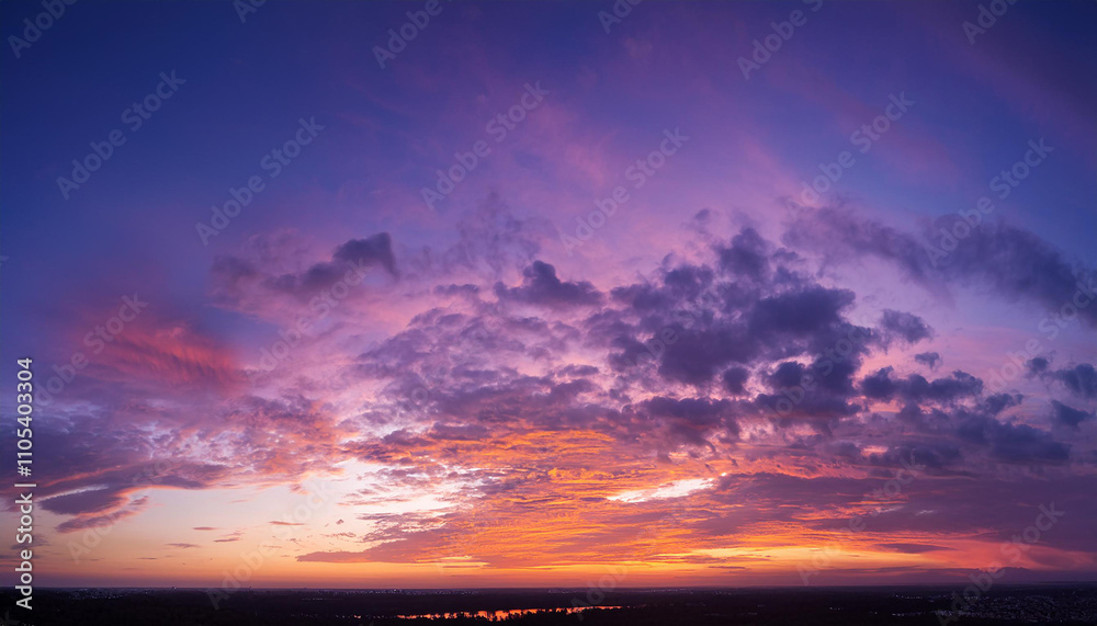 Obraz premium Dreamy sunset horizon painted in violets and pinks, soft orange and peach tones. Wispy cloud trails