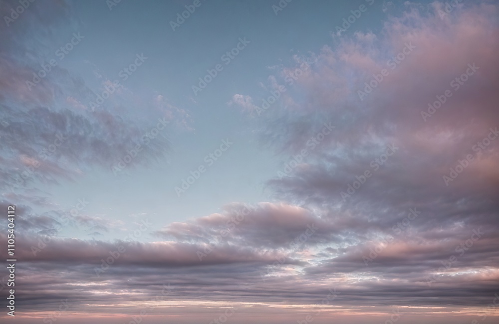 Fototapeta premium Cloudy sky with pink and blue tones at sunset.
