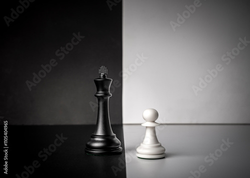 Conceptual composition with chess pieces in dramatic light, duality, good versus evil, darkness versus light, conflict.