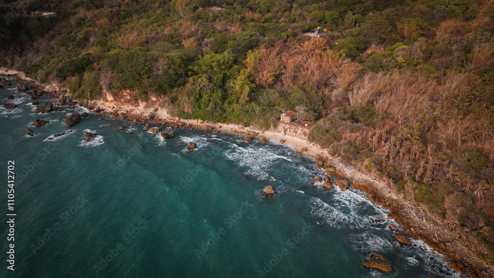 Afternoon coastal view of Taiwan rocky shoreline and lush greenery