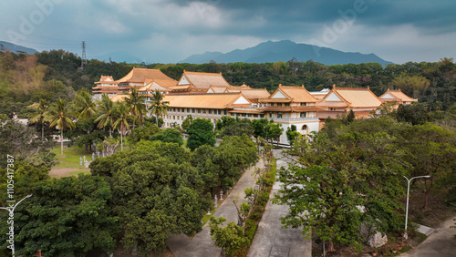 Shenwei Tiantaishan Monastery surrounded by lush greenery in Taiwan on a cloudy day photo