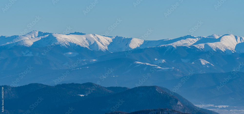 Fototapeta premium Nizke Tatry mountains between Chopok and Kotliska hill from hiking trail bellow Stoh hill summit in winter Mala Fatra mountains in Slovakia