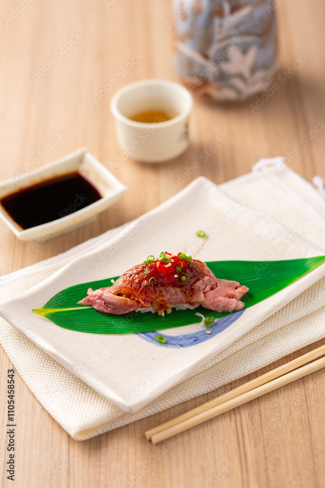 Fresh Sushi on Leaf Plate with Sauce and Tea