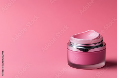 A beautiful pink cream-filled jar with a sleek silver lid is perfectly styled against a pink background, symbolizing femininity and care.