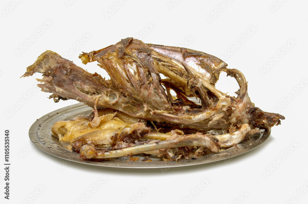 A plate of meat with bones and fat on it A plate of meat with bones and fat on it