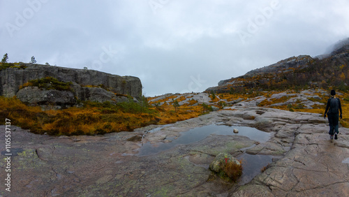 Rocky Landscape with Sparse Vegetation and Cloudy Sky