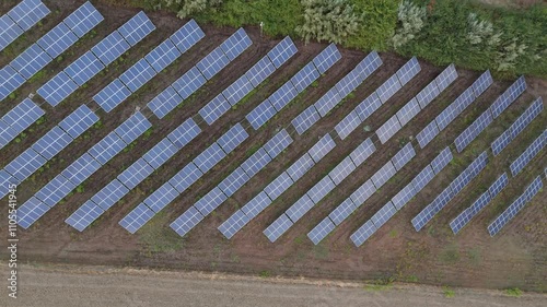 installation of solar panels on a hill with crops on the side in Italy at sunset with view from the top