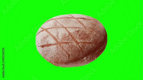 Brown bread with flour is spinning on green screen chroma key closeup