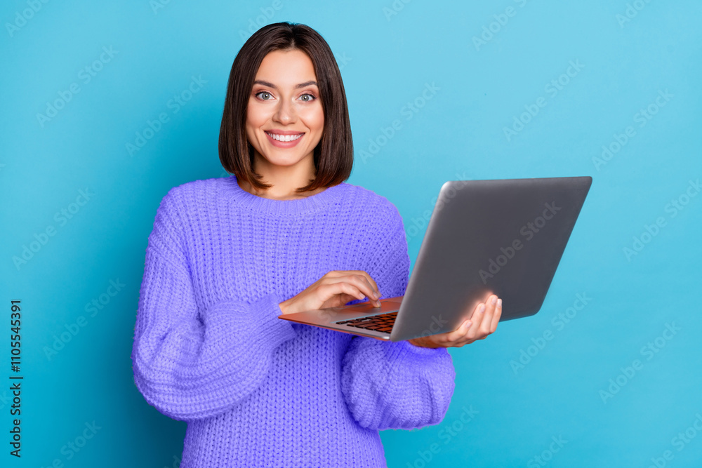 Portrait of attractive cheerful brown-haired girl using laptop developing project isolated over bright blue color background Portrait of attractive cheerful brown-haired girl using laptop developing project isolated over bright blue color background