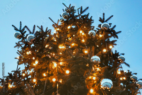 Christmas tree with silver bobbles outside in the evening, Christmas decorations, decorations in the city