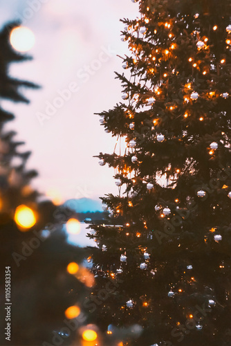 Christmas tree with silver bobbles outside in the evening, Christmas decorations, decorations in the city