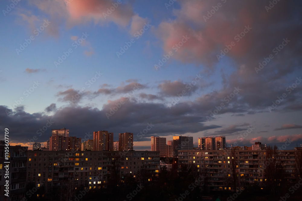 Fototapeta premium Dramatic Sunset Clouds Over City Skyline