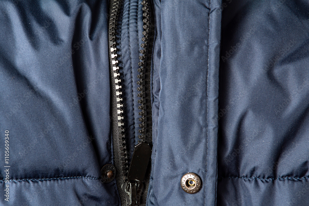 Texture of black warm down jacket with zipper as background, close-up Texture of black warm down jacket with zipper as background, close-up