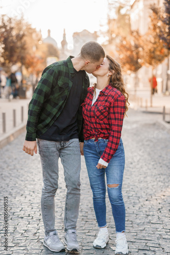 Romantic Kiss between Stylish Couple in Urban Setting