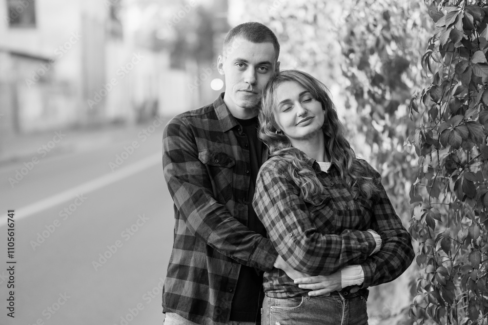 Romantic Black and White Portrait of a Young Couple Embracing on a City Street Romantic Black and White Portrait of a Young Couple Embracing on a City Street