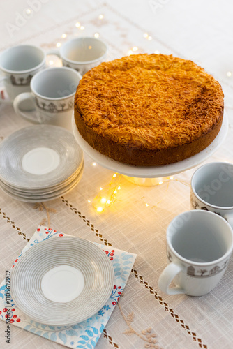 Homemade pie with cherry confit and sour cream souffle on laid table for tea party