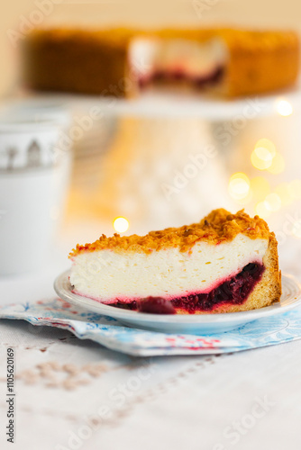 Homemade pie with cherry confit and sour cream souffle on laid table for tea party